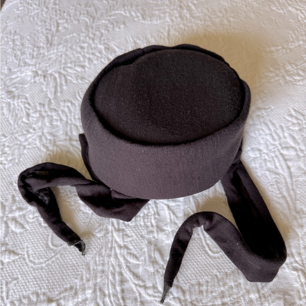 Womens vintage black pillbox hat with side tie flaps